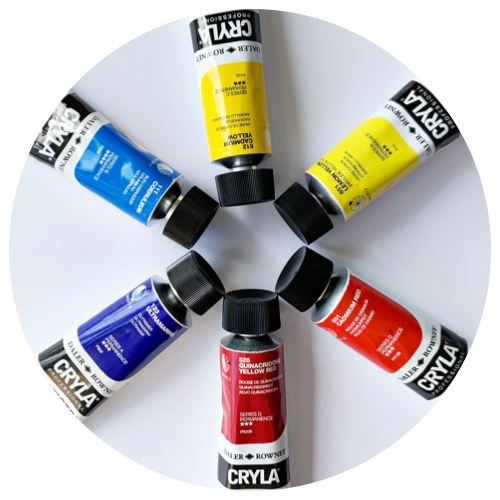 Picture of six Cryla Heavy Body Acrylic paint tubes (colours from top left in a circle to bottom left - Coeruleum, Cadmium Yellow, Lemon Yellow, Cadmium Red, Quinacridone Yellow Red and Ultramarine) arranged in a circle on a white background.